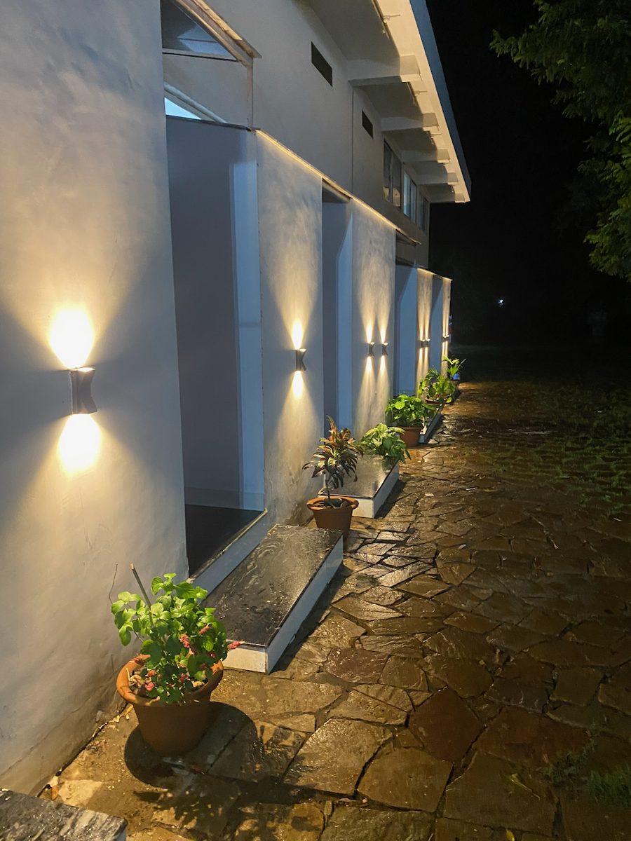 Wall lamps lighting the path along the rooms