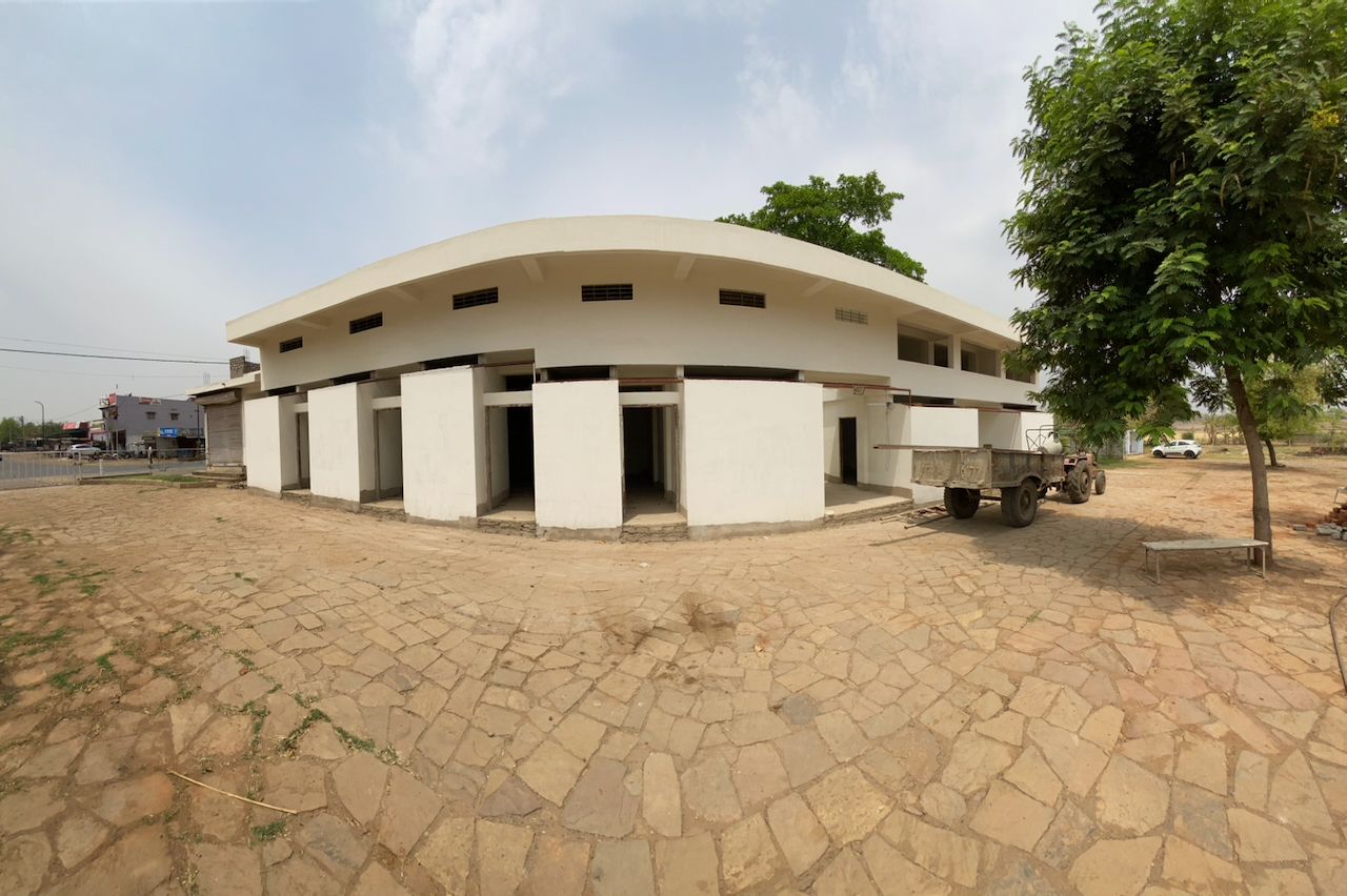 The white guest wing and its stone courtyard by day