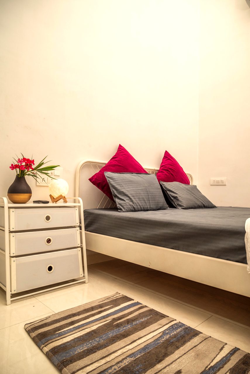 The Premium bed with a striped runner rug